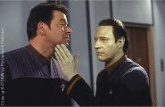 Data runs his finger along Riker's chin